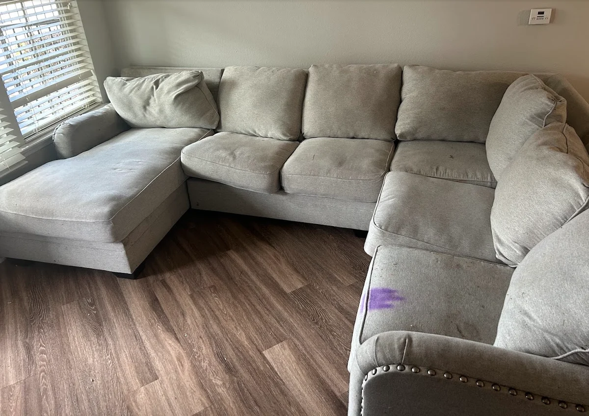 Light sectional before Cleaning Time service with a visible purple stain